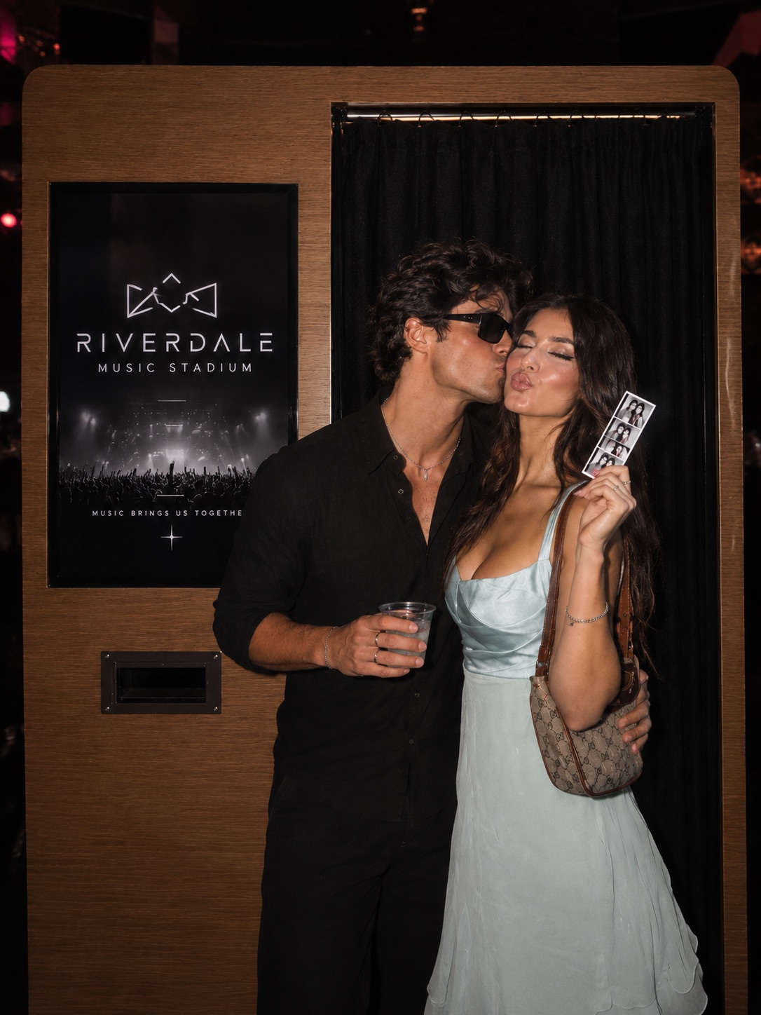 Couple posing at Riverdale Music Stadium's branded photo booth